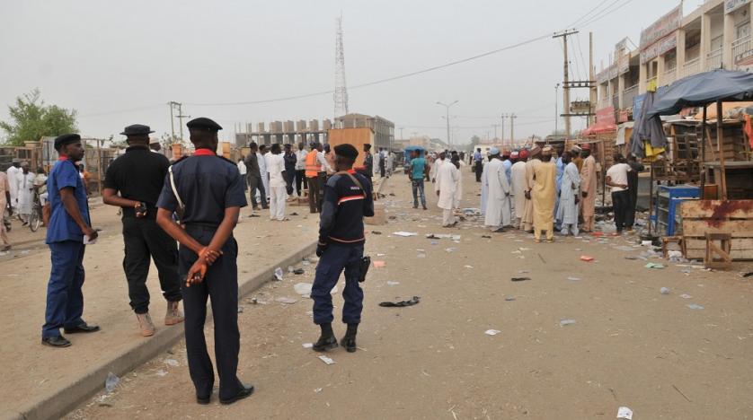 security officers stand guard at the scene of an explosion in nigeria. ap - حرية برس Horrya press